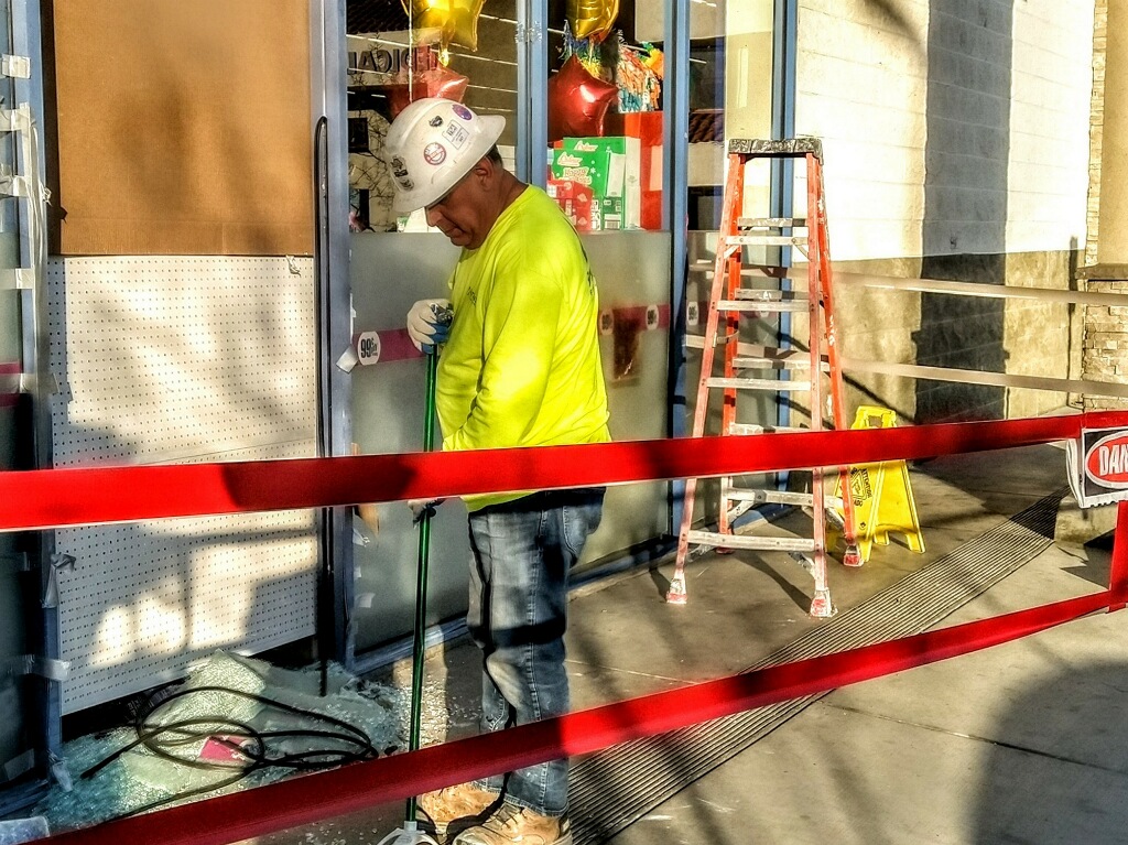 Man Cleaning Up Broken Glass